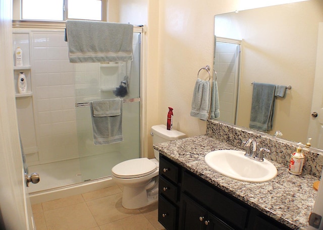 bathroom with vanity, tile patterned floors, toilet, and walk in shower