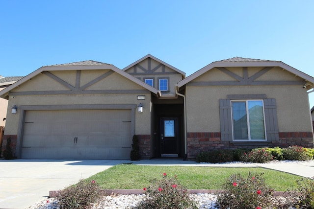 view of front of property with a garage and a front lawn