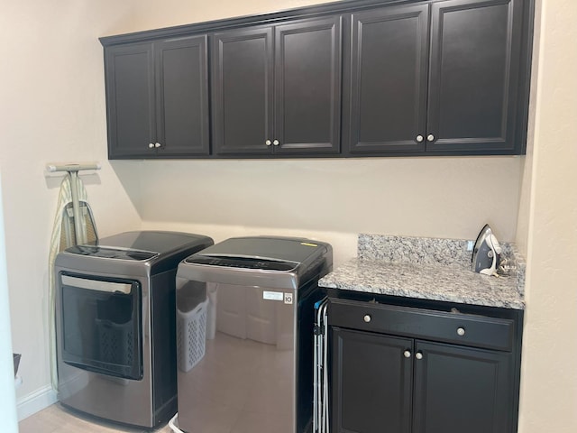 laundry area featuring cabinets and washing machine and clothes dryer