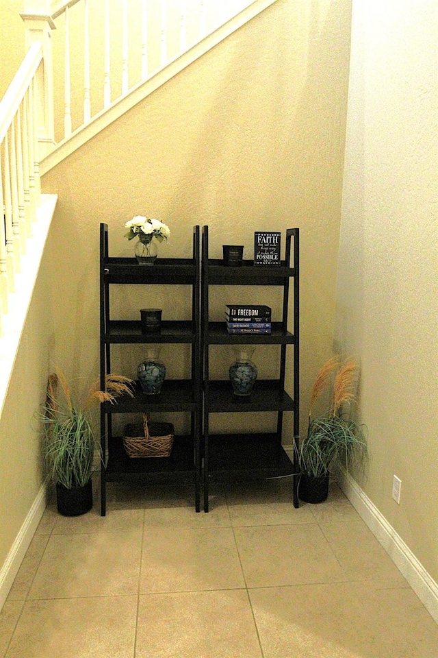 stairway with tile patterned flooring