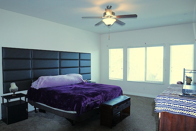 bedroom featuring ceiling fan and dark carpet