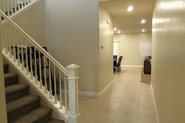 stairway with tile patterned floors