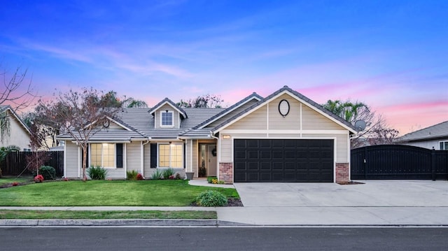 view of front of home with a lawn and a garage