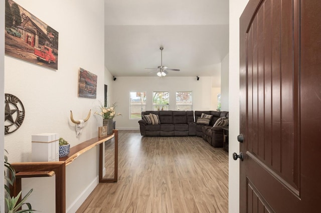 living room featuring ceiling fan and light hardwood / wood-style floors