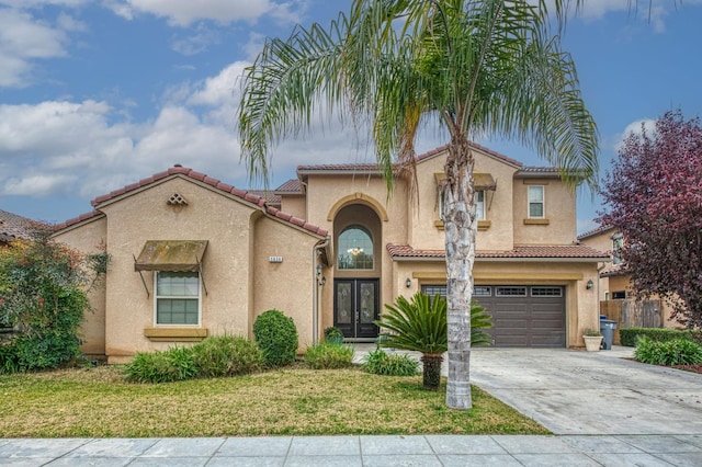 mediterranean / spanish house featuring a front lawn and a garage