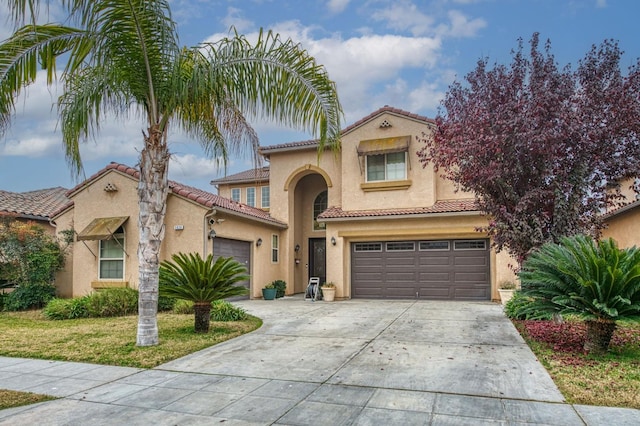 mediterranean / spanish home with a garage