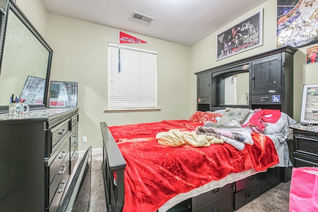 carpeted bedroom featuring a textured ceiling