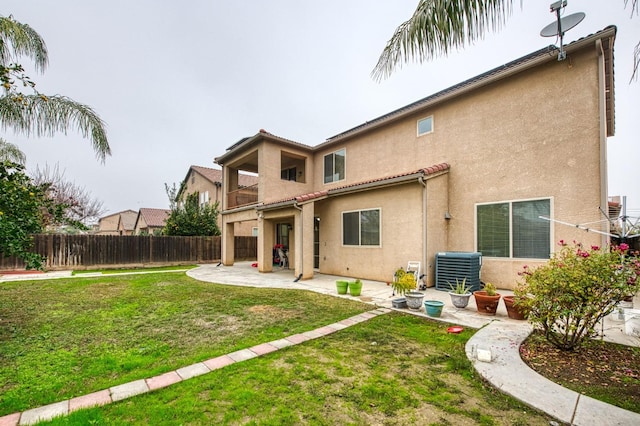 back of property featuring a patio, cooling unit, and a lawn