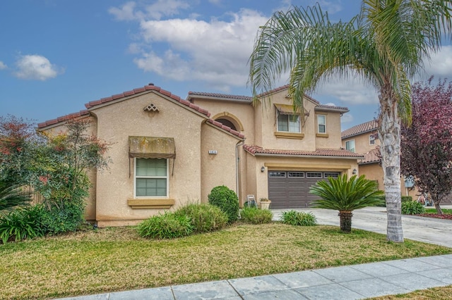 mediterranean / spanish-style home featuring a front lawn and a garage