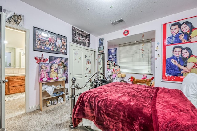 bedroom featuring carpet and a textured ceiling