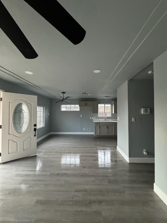 entryway with ceiling fan, hardwood / wood-style flooring, and a textured ceiling