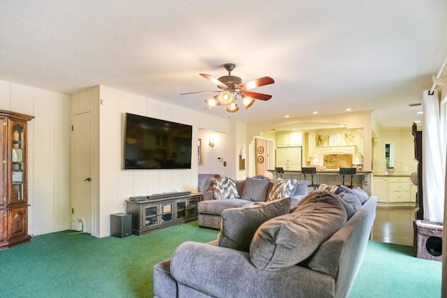 living room with carpet flooring and ceiling fan