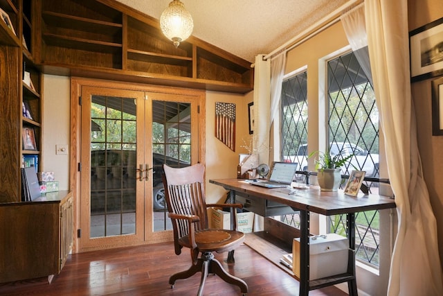 office featuring a textured ceiling, french doors, dark hardwood / wood-style floors, and lofted ceiling