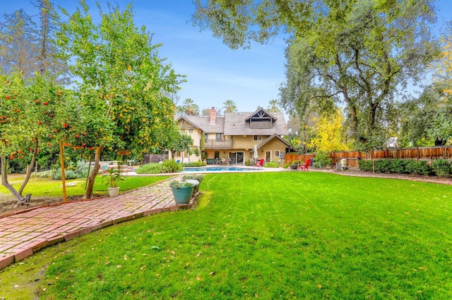 view of yard with a fenced in pool