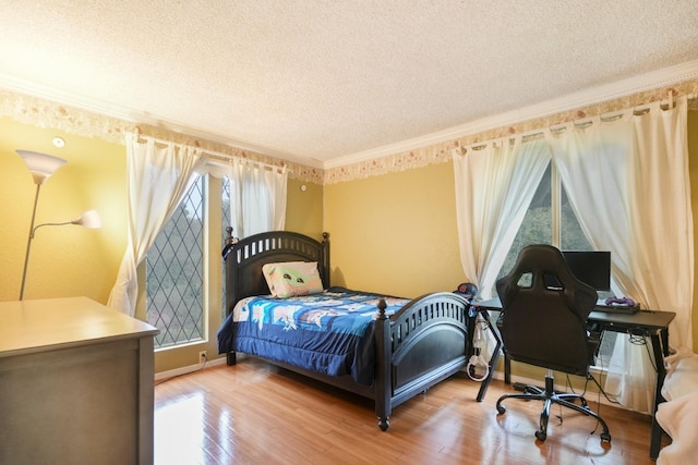 bedroom featuring a textured ceiling, wood-type flooring, and ornamental molding