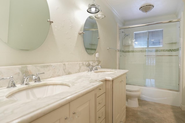 full bathroom with combined bath / shower with glass door, tile patterned floors, toilet, vanity, and ornamental molding