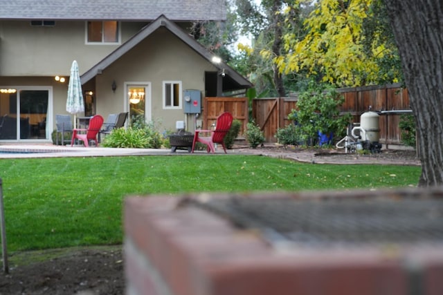 rear view of house with a yard and a patio