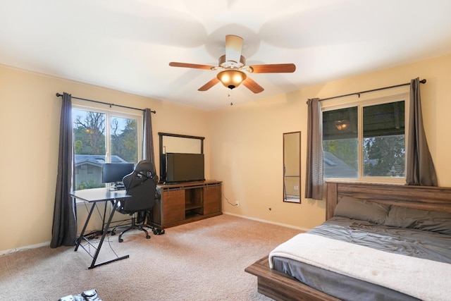 bedroom featuring light colored carpet and ceiling fan