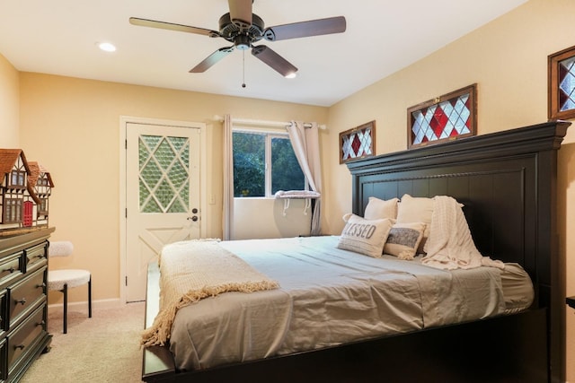 bedroom featuring ceiling fan and light carpet