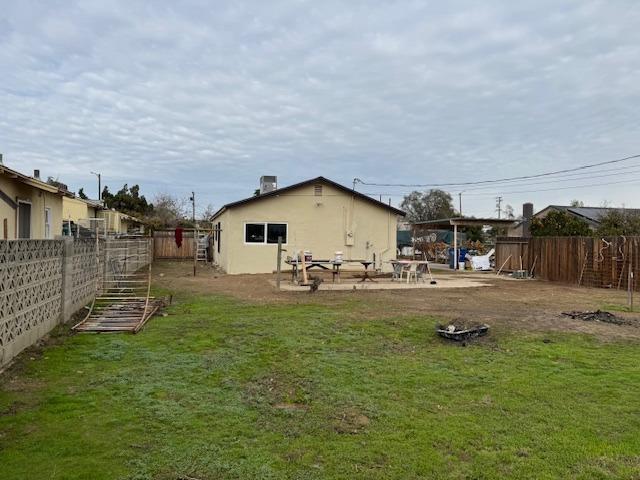 rear view of house featuring a yard