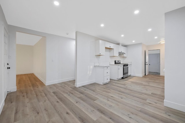 kitchen with white cabinetry, stainless steel range, and light wood-type flooring