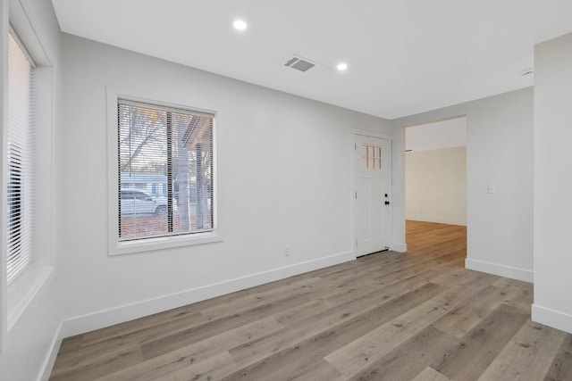 unfurnished room with light wood-type flooring