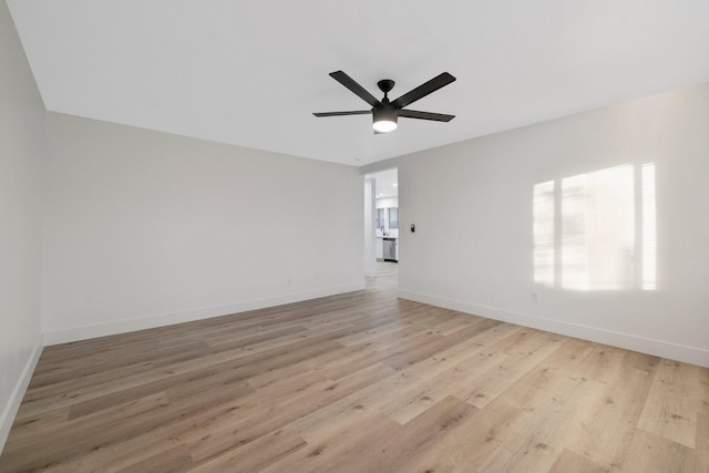 empty room with ceiling fan and light hardwood / wood-style floors