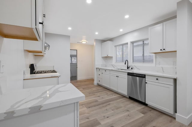 kitchen with dishwasher, white cabinets, light hardwood / wood-style floors, and sink