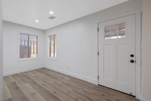 foyer entrance with light hardwood / wood-style floors