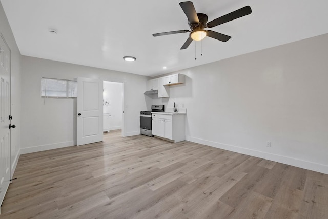 unfurnished living room featuring light wood-type flooring and ceiling fan