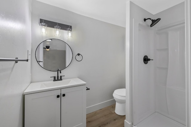 bathroom with a shower, vanity, wood-type flooring, and toilet