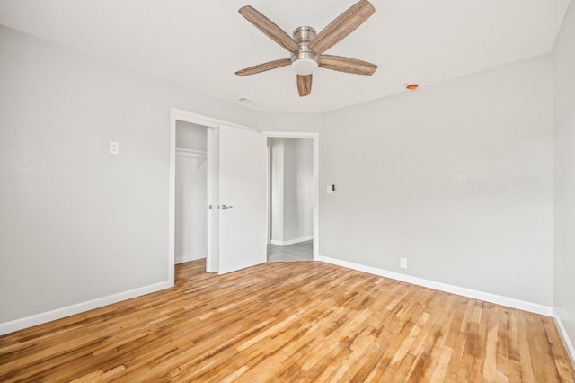 unfurnished bedroom featuring light hardwood / wood-style floors, a closet, and ceiling fan