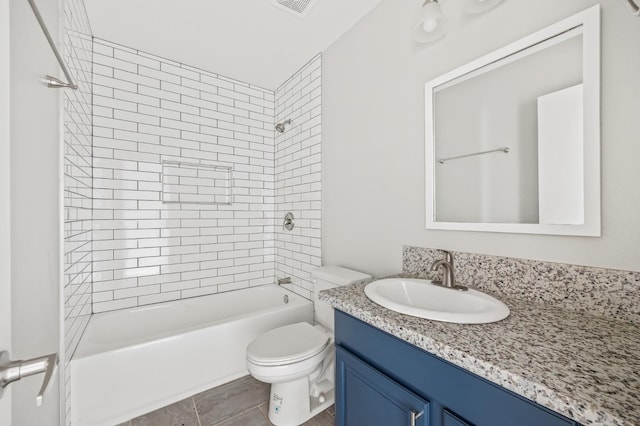 full bathroom featuring vanity, toilet, and tiled shower / bath