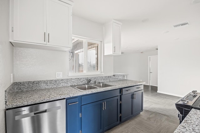 kitchen featuring white cabinetry, sink, stainless steel dishwasher, light stone counters, and blue cabinetry