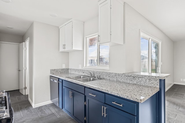 kitchen with blue cabinets, dishwasher, sink, white cabinets, and light stone countertops