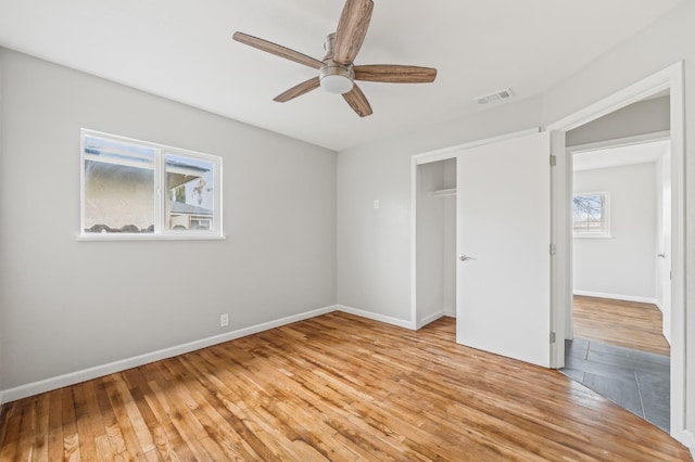 unfurnished bedroom with ceiling fan, light hardwood / wood-style floors, and a closet