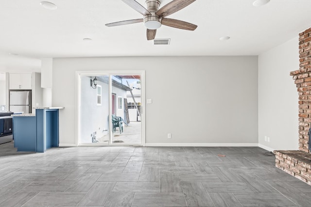 unfurnished living room with ceiling fan