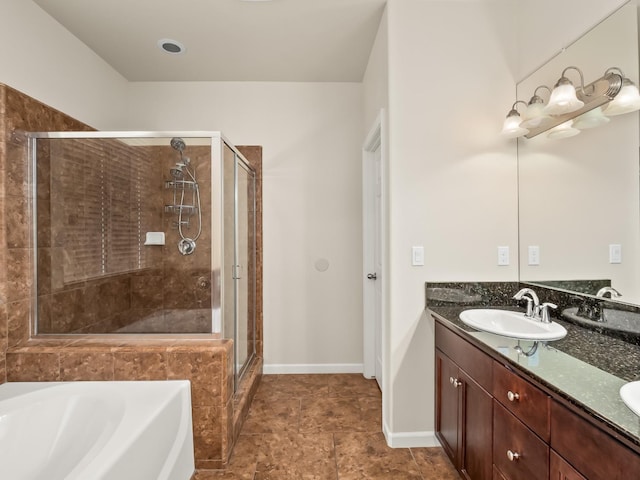 bathroom with vanity and separate shower and tub