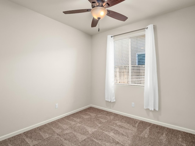 spare room with ceiling fan and carpet