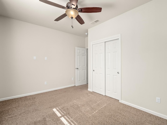 unfurnished bedroom with carpet flooring, a closet, and ceiling fan