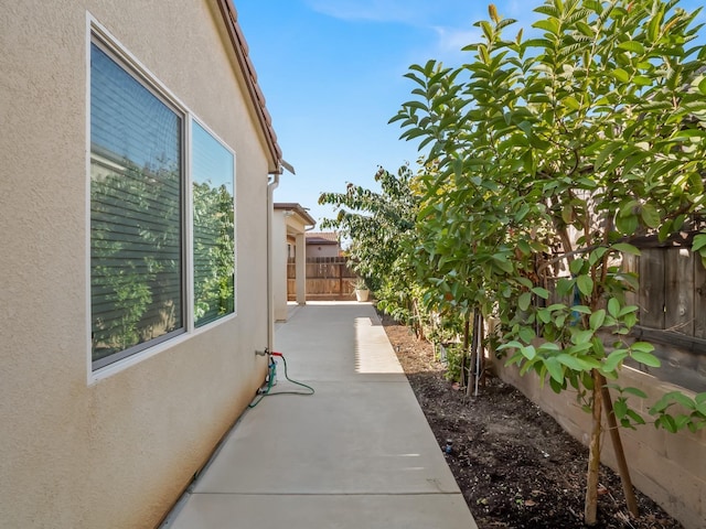 view of side of home with a patio area