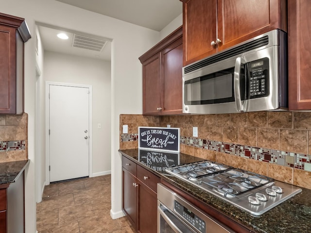 kitchen featuring dark stone countertops, decorative backsplash, and stainless steel appliances