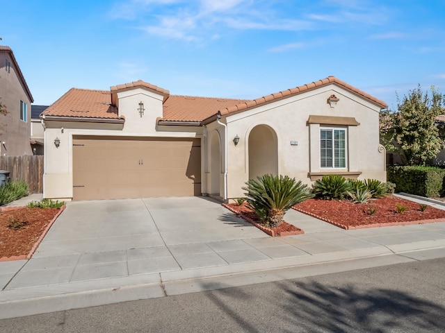 mediterranean / spanish-style house featuring a garage