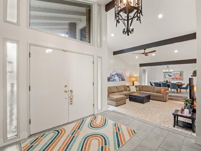 tiled foyer entrance with ceiling fan with notable chandelier, beam ceiling, and high vaulted ceiling