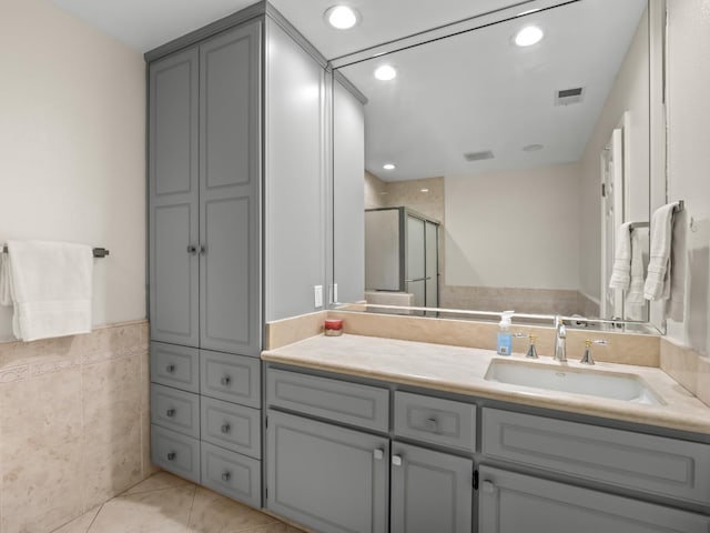 bathroom featuring vanity, tile patterned floors, and a shower with shower door