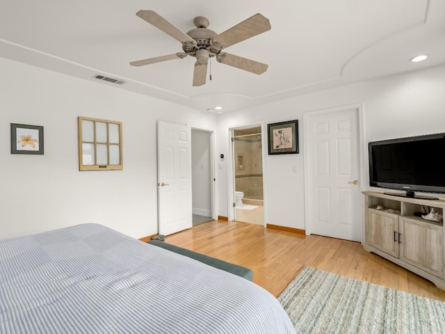 bedroom featuring ensuite bath, light hardwood / wood-style flooring, and ceiling fan