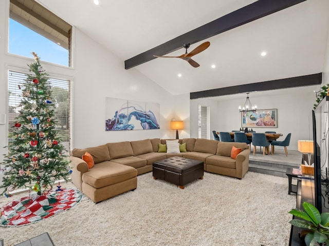 carpeted living room with beamed ceiling, ceiling fan with notable chandelier, and high vaulted ceiling