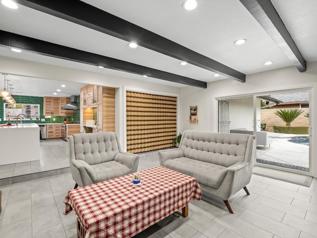 tiled living room featuring beamed ceiling and sink