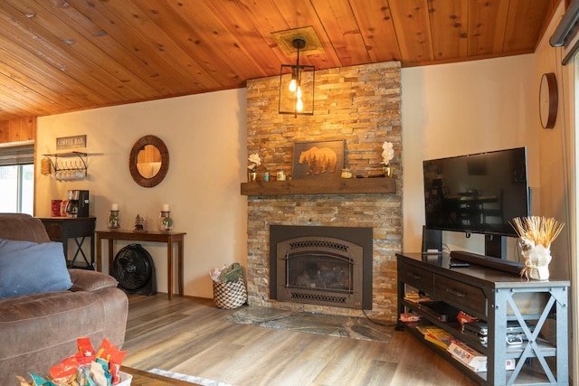 living room featuring a stone fireplace, wood-type flooring, and wooden ceiling