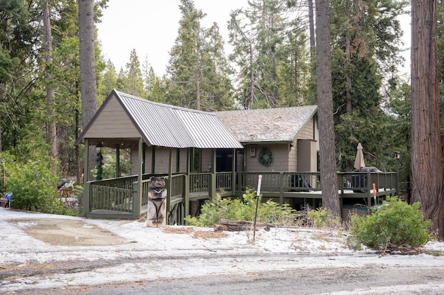 42135 Hanging Branch Rd, Shaver Lake, CA 93664 - view of front facade with a deck, a metal roof, and view of scattered trees